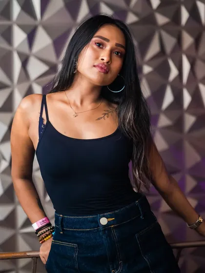 A guest posing against the textured wall, a popular photo spot.