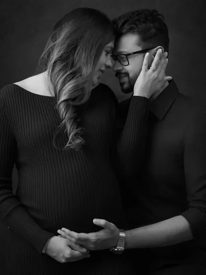 The same intimate pose, rendered in black and white to emphasize emotion and form. Monochrome portraits offer a timeless, artistic quality that I love to provide as part of a gallery.