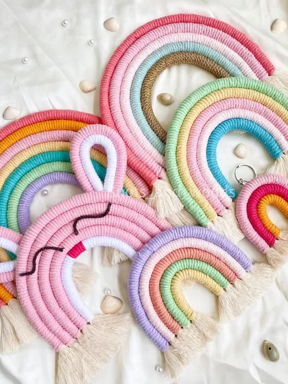 Rainbows for days! This photo shows the wonderful variety of macrame rainbows I can create, from large pastel wall hangings and cute animal-themed rainbows to tiny little keychains. There's a rainbow for every space and occasion.