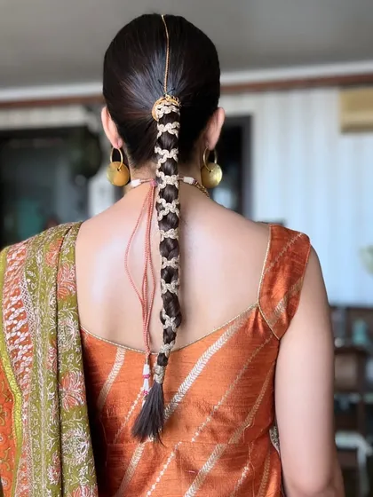 A detailed shot of the traditional braided hairstyle we created for Aaliyah Kashyap's Mehendi. The intricate weaving and accessories are a key part of the complete look.