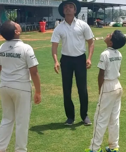 An umpire and two U-12 captains at the toss, a crucial learning experience in leadership and sportsmanship.