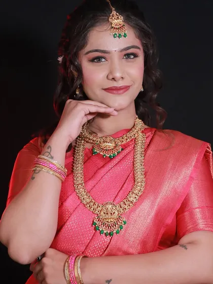 A front-facing portrait of a student's South Indian bridal makeup, showcasing their skill with traditional jewelry and makeup.