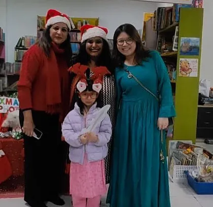 It's always a joy to celebrate with the families that make up our community. Posing for a photo at our Christmas picture booth after a fun-filled session of stories and crafts.