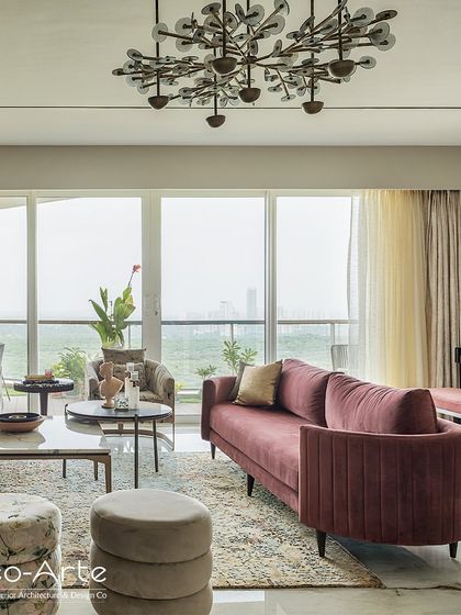 Join me on a voyage of design discovery. This living room, with its stunning view and unique chandelier, is a space that tells a story where every detail speaks volumes.