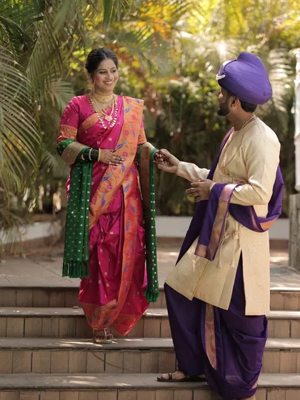 A playful and happy moment between the traditionally dressed couple.