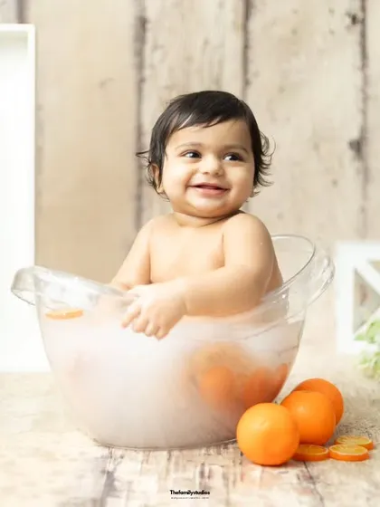 A beautiful, smiling portrait of a baby enjoying her warm and relaxing milk bath.