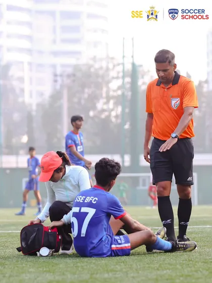 An important part of the game is learning resilience. Here, a physio attends to a player on the field, showing our commitment to player welfare and getting them back on their feet.