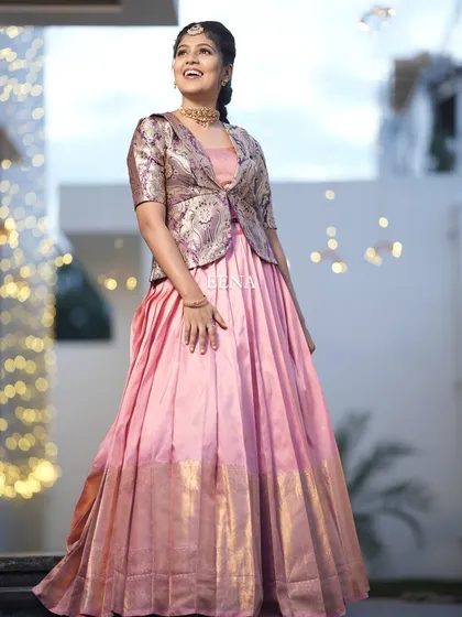My beautiful client looks so charming in this custom housewarming outfit. I paired a flowing peach Kanchi-border skirt with a chic brocade jacket, blending traditional fabric with a modern, layered silhouette.
