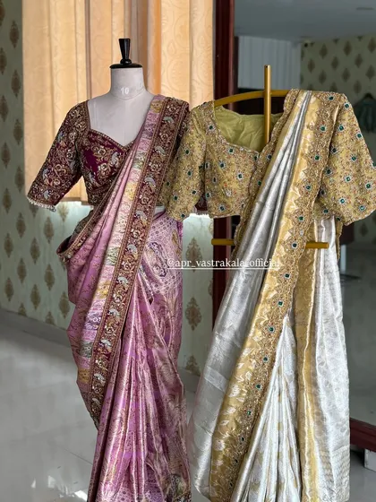 We offer a range of exclusive bridal collections. Here, our maroon peacock-motif half-saree is displayed next to a gold and silver ensemble, showing different options for your big day.