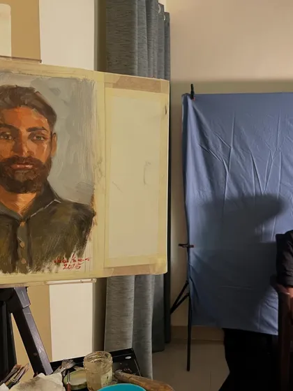 A side view of the portrait of Rishabh in progress. This angle shows how the painting is built up on the easel during the live sitting.