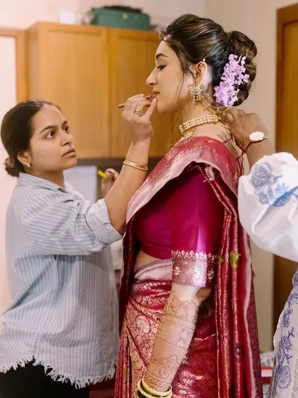 Me in my element, giving the final touches to Shalmali's classic Marathi bridal look. It's all about ensuring every detail is perfect.