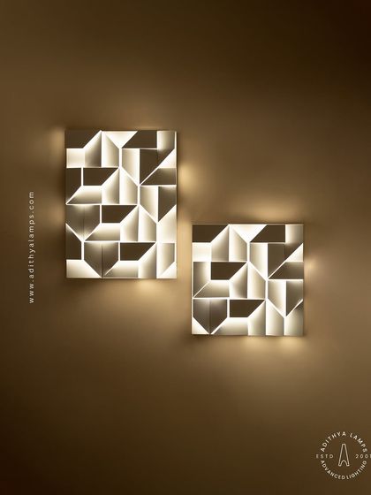 This 3D geometric wall light plays with light and shadow. The puzzle-like arrangement of white panels creates pockets of light, turning a simple wall into a dynamic feature. It is a perfect piece of illuminated wall art.