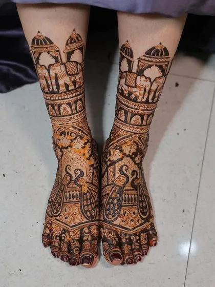 Bridal feet deserve just as much love. I created this symmetrical design featuring royal elephants under a jharokha and elegant peacocks, ensuring the bride looks perfect from head to toe.