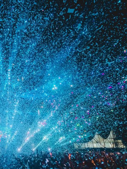 The explosive start to the show, with blue confetti cannons firing over the crowd.