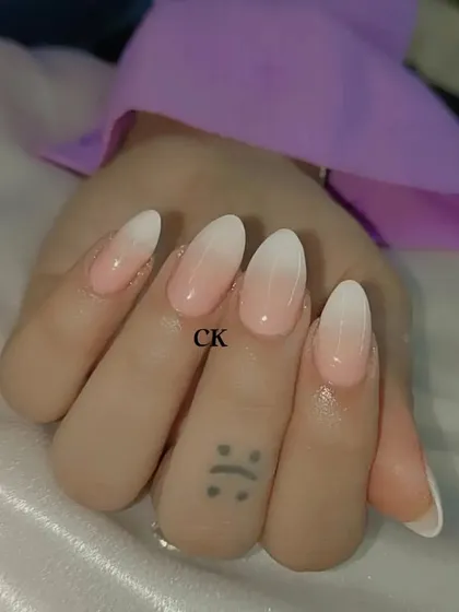 A beautifully executed baby boomer set on almond-shaped nails. The seamless gradient from pink to white is a testament to clean, technical work.