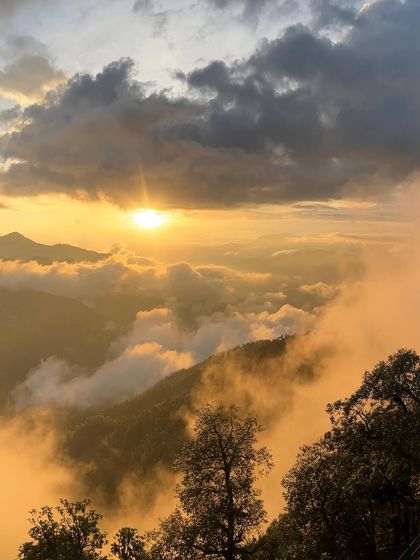 A breathtaking sunset over the clouds in the mountains. Capturing nature's beauty is one of my favorite parts of travel content creation.