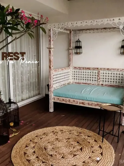 We believe every home needs a corner for peace. This balcony was transformed with an ornate daybed, potted plants, and soft lighting to create a perfect, cozy spot for rest.