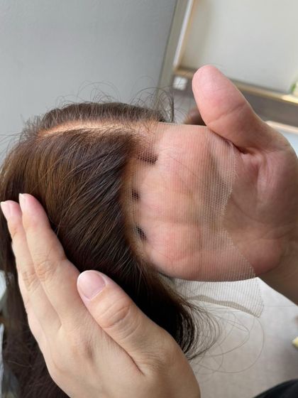 From this to that. This image shows the transparent lace of a wig before application, demonstrating how it's designed to melt into the skin for a natural finish.