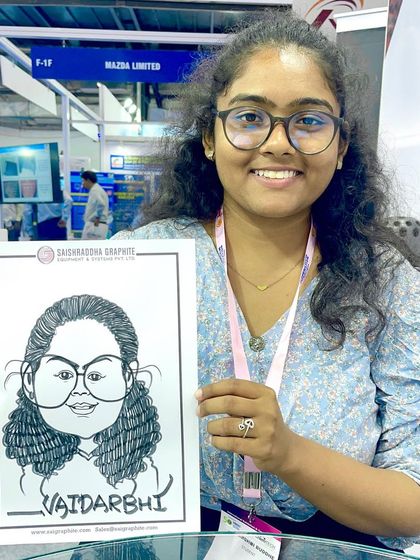 This visitor at the Bombay Exhibition Centre was pleased with her caricature, which featured the event sponsor's branding.