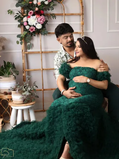 A close-up of the couple's loving gaze. The dark green gown adds a touch of sophisticated color to the boho setup.
