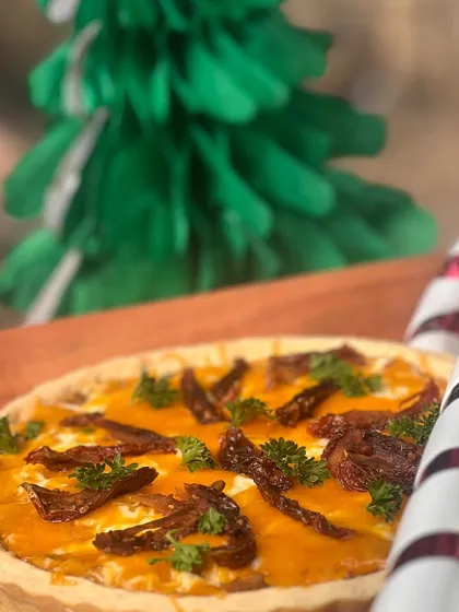 A savory sun-dried tomato quiche, a perfect addition to a festive brunch or high-tea menu.