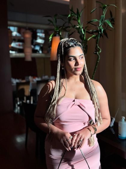 Another shot in the pink dress and braids, capturing a moment in the golden hour light. The lighting really makes the different tones in the braids pop.