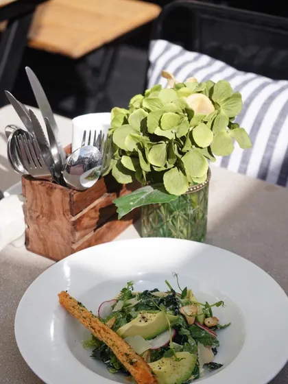 A beautifully set table at our India Art Fair restaurant. We provide a lovely vibe for visitors to enjoy CAARA classics like fresh salads and our morel risotto.