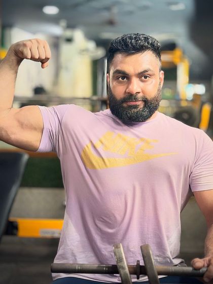 The look of determination. A client takes a moment after a tough set. The strength and size in his arms are a testament to his hard work and our training plan.