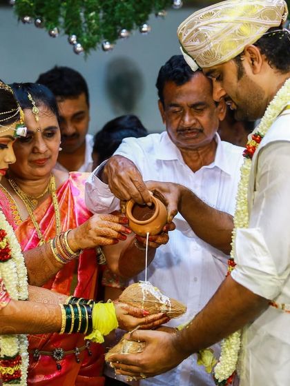 Family members come together to bless the couple in a traditional pouring ritual, a moment of unity and love.