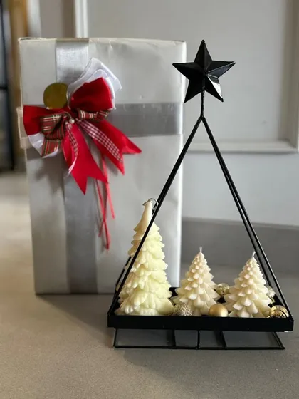 A clean and modern Christmas look, with a white wrapped gift and a set of my white tree candles in a black metal holder.