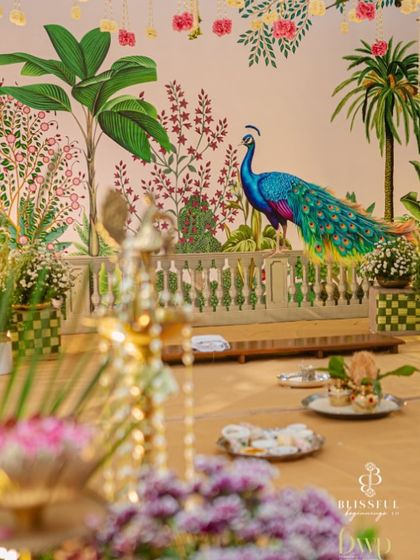A detail shot of the hand-painted peacock on the mandap backdrop. The vibrant colors and graceful posture of the peacock, a symbol of beauty and divinity, made it a stunning focal point.