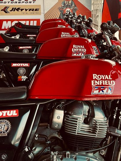 A lineup of our red Royal Enfield GT 650 training bikes, gleaming and ready for action.
