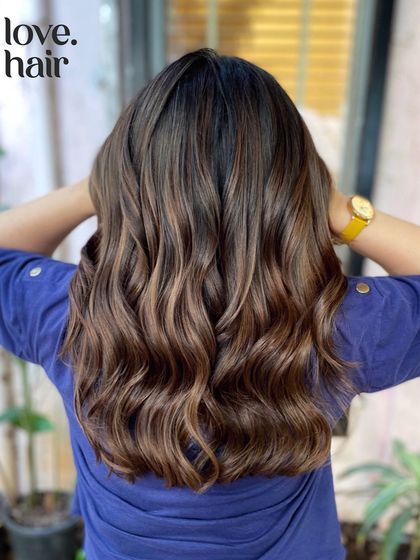A beautiful mocha-inspired balayage. The mix of indoor and outdoor lighting shows how the colour shifts, revealing different dimensions of the cool and warm brown tones.
