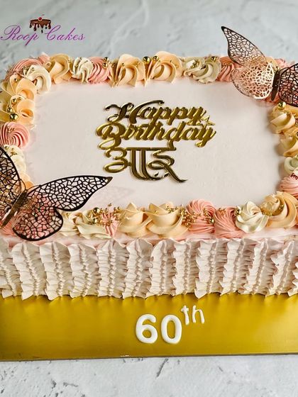 A beautiful sheet cake for 'Aai's' 60th birthday, decorated with pastel rosettes and elegant butterflies.