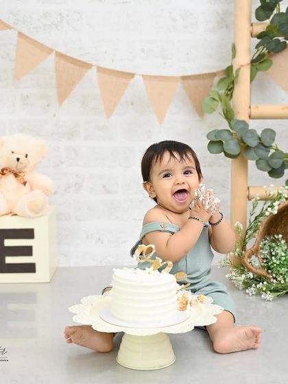 A big, frosting-filled laugh! Capturing these moments of pure, uninhibited joy is the best part of any cake smash photoshoot. His happiness is absolutely infectious.