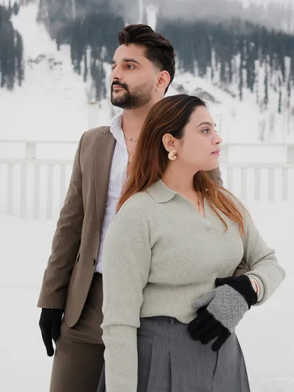 A stylish pose against the snow-covered mountains of Kashmir. This shot combines fashion-forward posing with a majestic natural background for a unique pre-wedding look.