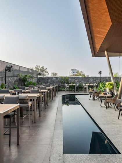 'Terns', a restobar in Coimbatore by Ksquare Architects, features an expansive outdoor terrace with a reflective water channel, seamlessly fusing architecture and landscape.