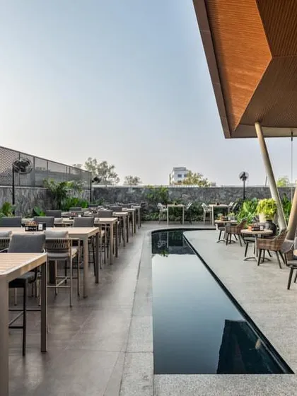 'Terns', a restobar in Coimbatore by Ksquare Architects, features an expansive outdoor terrace with a reflective water channel, seamlessly fusing architecture and landscape.