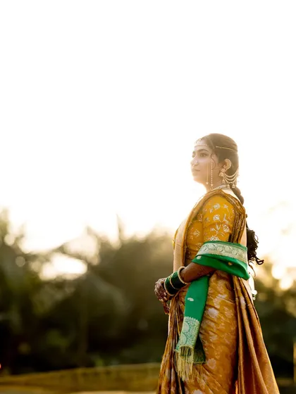 An atmospheric shot of the bride against a bright sky, looking regal and timeless.
