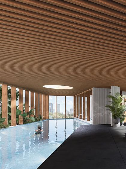 The indoor swimming pool from the mid-rise coastal residence in Mumbai. We designed this space to feel like a private oasis, with a slatted wood ceiling and views of the city, blending luxury with natural elements.