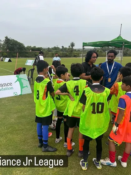 A coach giving a pre-match talk to our U11 team during the Reliance Jr League. Tactical instruction is a key part of our program.