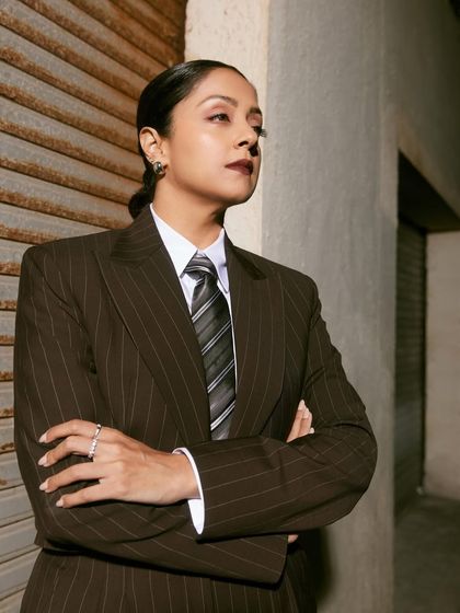 An arms-crossed power pose that perfectly captures the commanding presence of this suit and tie combination.