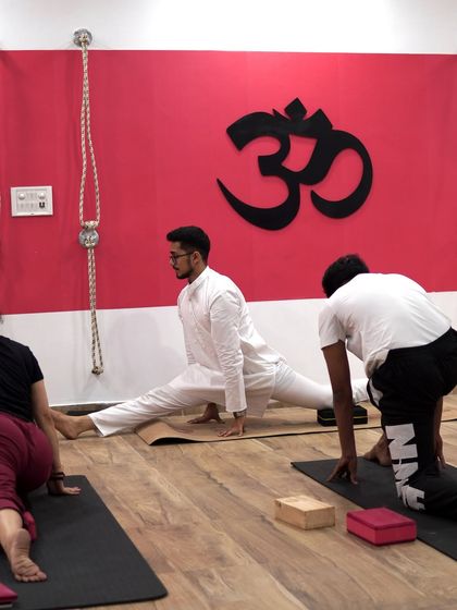 Flexibility is earned, not given. Here, I am demonstrating Hanumanasana (the splits) to my class, showing that with consistent practice, even the most challenging poses become accessible.