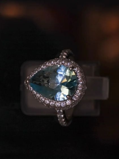 A beautifully lit shot of our large teardrop aquamarine-colored zirconia ring, showing the facets and fire of the stone.