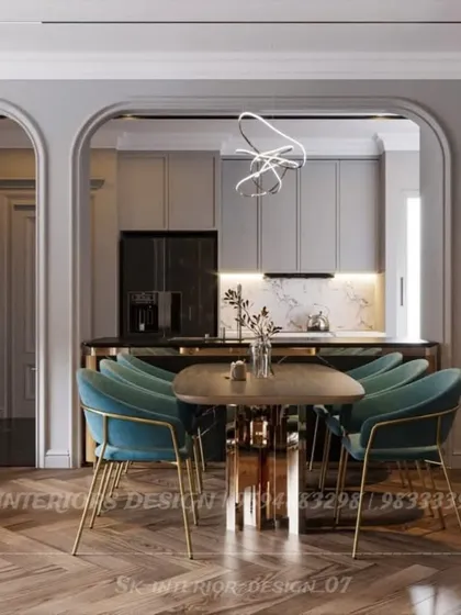 This view shows how an arched opening can beautifully frame the dining and kitchen area. The design uses consistent materials and colors to create a harmonious flow between the different zones.