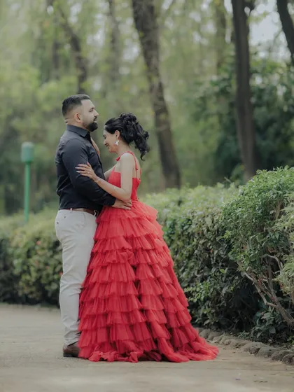 A tender moment of embrace between the couple in a beautiful Pune garden. The composition draws the eye to their connection, making it a perfect example of a romantic and cinematic engagement photo.