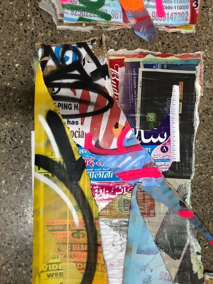 A close-up of the textures in a 'Stick No Bills' piece. Notice the mix of commercial print, hand-painted lettering, and the raw edges of the torn paper layers.