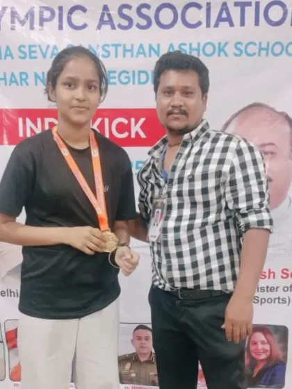 One of our female athletes with her medal at the Delhi Olympic Games. We encourage and train girls to become strong, confident fighters.