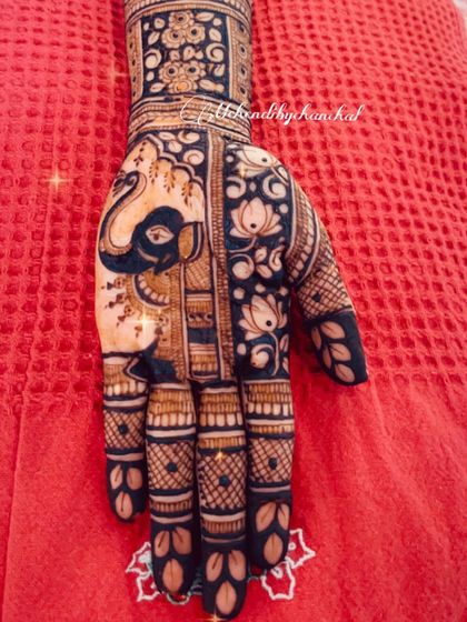 A close-up of a bridal palm, featuring a large, bold elephant design surrounded by delicate lotus patterns.