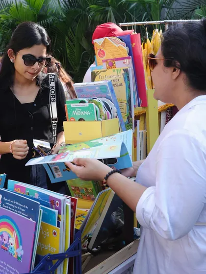 Here I am helping a customer choose the right book for her child. I love having these one-on-one conversations and giving personalized recommendations based on a child's reading level and interests.